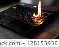 The computer laptop is burning with flames 126153936