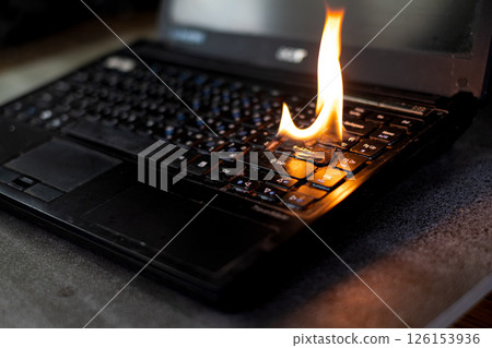 The computer laptop is burning with flames 126153936