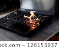 The computer laptop is burning with flames 126153937