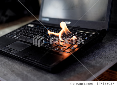 The computer laptop is burning with flames 126153937