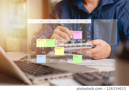 businessman planning his tasks using a calendar and to-do list on a smartphone. Efficient time management, work planning, and productivity concept. 126154015