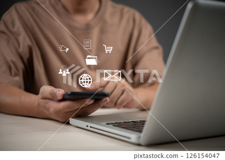 Digital business tools concept with user holding smartphone, using cloud apps for email, shopping, marketing, communication, ads and file management. 126154047