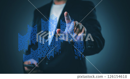 business professional analyzing digital representations of building growth and market trends using futuristic data visualization tools. 126154618