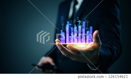 Businessman holding glowing bar chart with upward arrows, symbolizing business growth, financial success, data analytics, investment forecast and digital strategy. 126154621