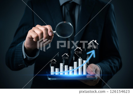 businessman analyzing real estate market growth using a magnifying glass and digital graphs, representing the future of housing investments. businessman analyzing real estate market growth using a magnifying glass and digital graphs, representing the future of housing investments. 126154623