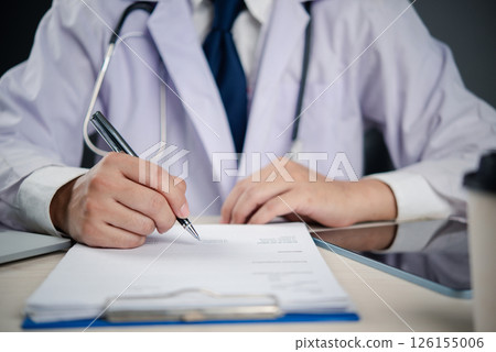A doctor writing on a medical form or prescription clipboard, symbolizing healthcare documentation, patient diagnosis, and professional treatment planning. A doctor writing on a medical form or prescription clipboard, symbolizing healthcare documentation, patient diagnosis, and professional treatment planning. 126155006