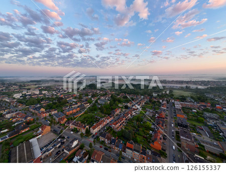 Aerial View Capturing the Serene Beauty of a Vibrant Sunrise Over a Charming Small Town 126155337