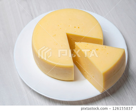 Round Cheese with Large Triangle Slices Round Cheese with Large Triangle Slices 126155837