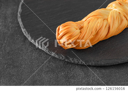 chechil cheese pigtailed on slate stone plate, selective focus chechil cheese pigtailed on slate stone plate, selective focus 126156016