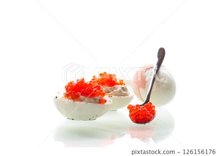 boiled eggs with red caviar on a white background 126156176