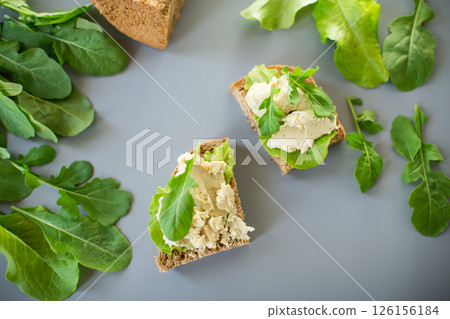 Appetizing sandwich with greens and fish spread 126156184
