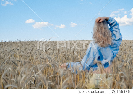 Pregnant girl in white shirt in golden wheat. High quality photo Pregnant girl in white shirt in golden wheat. High quality photo 126156326