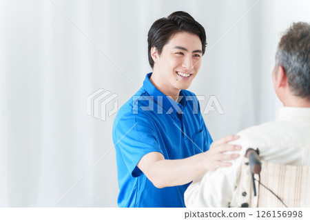 Male caregiver and elderly man in a wheelchair 126156998