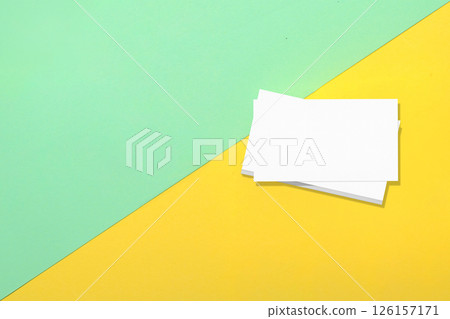 Top view of business business cards on colored background. Blank paper or sheet. Mockup or copy space for your design Top view of business business cards on colored background. Blank paper or sheet. Mockup or copy space for your design 126157171