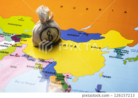 Map of China with a money bag of dollars. Concept of the United States of America versus China trade war disputes or economic conflict 126157213