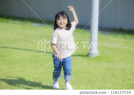 Kids playing on the grassy plaza 126157559