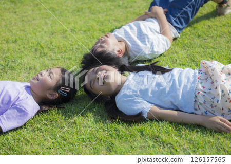 Kids playing on the grassy plaza 126157565
