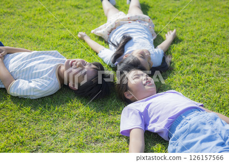 Kids playing on the grassy plaza 126157566