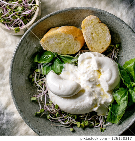 Traditional italian burrata knotted cheese in bowl Traditional italian burrata knotted cheese in bowl 126158317