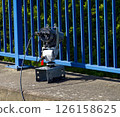 Modern security camera monitoring traffic flow on bridge 126158625