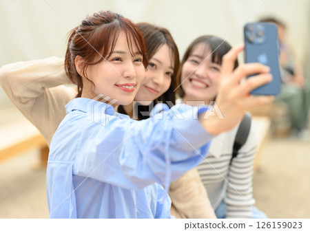Women taking photos to commemorate their trip 126159023