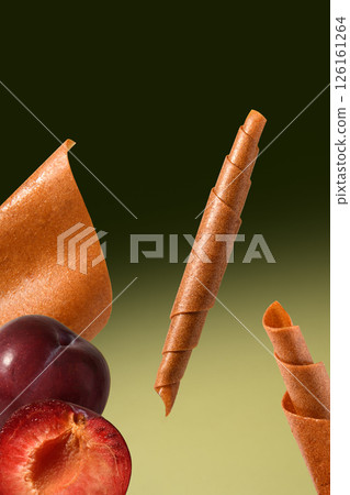 Lozenges in the air on a green background. Natural, healthy breakfast. Vitamins. Plum dessert. Lozenges in the air on a green background. Natural, healthy breakfast. Vitamins. Plum dessert. 126161264