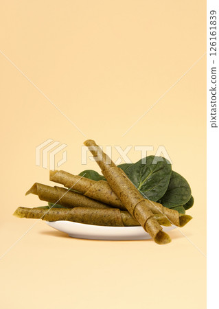 A plate of pastila with spinach on a beige background. Free space for text. 126161839