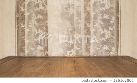 Wooden table with soft fabric curtains in the background creating a warm and inviting atmosphere Wooden table with soft fabric curtains in the background creating a warm and inviting atmosphere 126162805