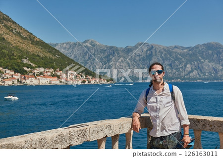 Man standing on an island in Kotor Bay, Summer vacation 126163011