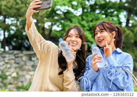 Women taking photos to commemorate their trip 126163112