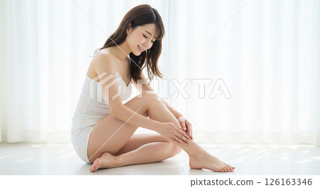 A woman taking care of her depilated legs. Swelling care, lymphatic massage. 126163346