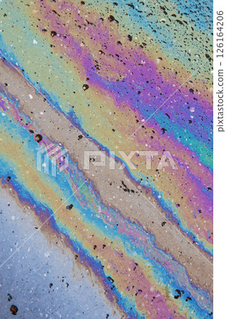 Color Gasoline fuel spots on Asphalt Road as Texture or Background. Iridescent stains of gasoline. Vertical. Color Gasoline fuel spots on Asphalt Road as Texture or Background. Iridescent stains of gasoline. Vertical. 126164206
