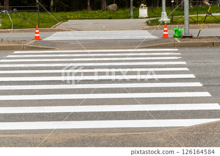 Freshly painted white lines defining pedestrian crossing on asphalt road Freshly painted white lines defining pedestrian crossing on asphalt road 126164584