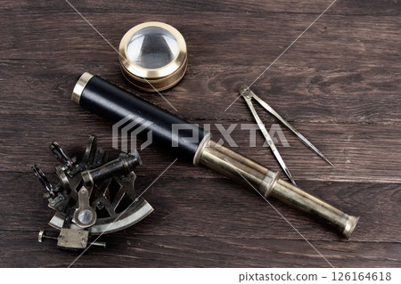 Antique bronze naval instruments - sextant, spy glass. naval dividers and magnifier glass 126164618