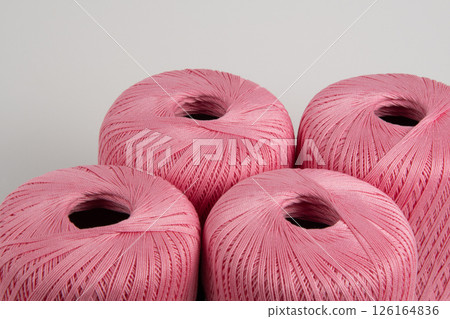 Spools of pink thread on a gray background. Photo for a banner. 126164836