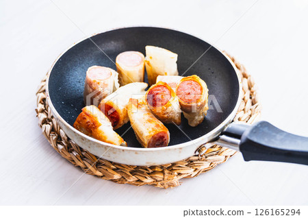 Crispy sausage fried in a frying pan Crispy sausage fried in a frying pan 126165294