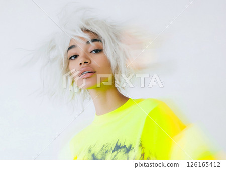Beautiful white hair model wearing neon yellow designer jumper during motion blur.AI Generative. 126165412