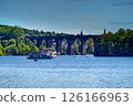 Tourists enjoying boat trip under railway bridge on the lahn river 126166963