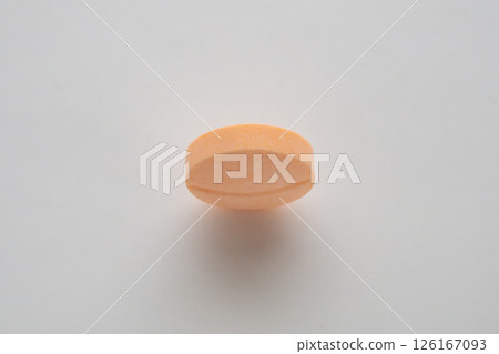 Orange medicine pill tablet on white background 126167093