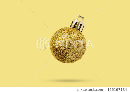 Golden Christmas ball isolated on yellow background 126167184