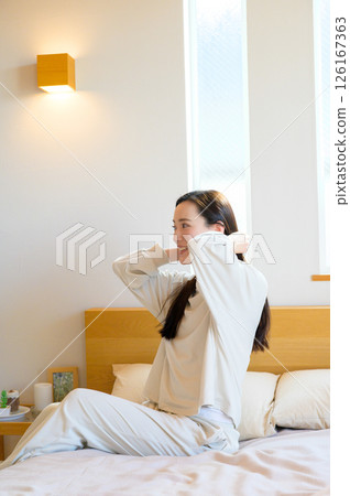 A Japanese woman relaxing in bed A Japanese woman relaxing in bed 126167363