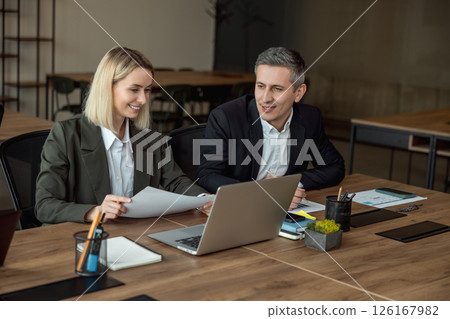 Lawyers working together on the project and looking interested and involved 126167982