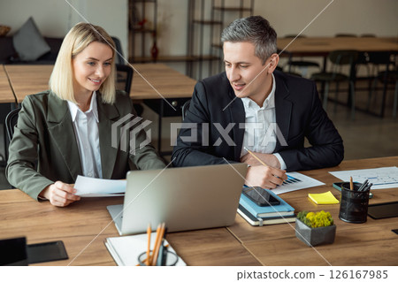 Lawyers working together on the project and looking interested and involved Lawyers working together on the project and looking interested and involved 126167985