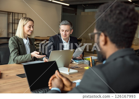 Lawyers working together on the project and looking interested and involved Lawyers working together on the project and looking interested and involved 126167993