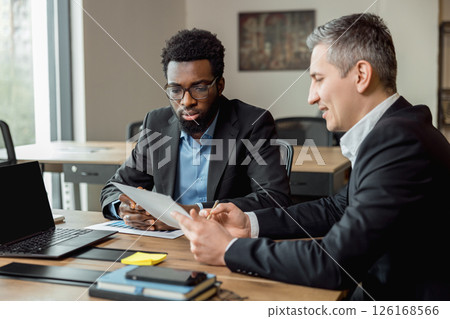 Business consultant talking to the client and looking involved Business consultant talking to the client and looking involved 126168566