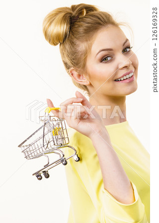Woman holding small shopping cart 126169328