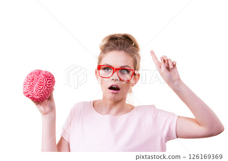 Shocked woman in eyeglasses holding human brain 126169369