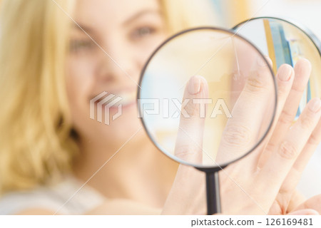 Woman using magnifer on nails Woman using magnifer on nails 126169481