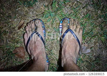 Dirty male feet in slipper with mud 126169815