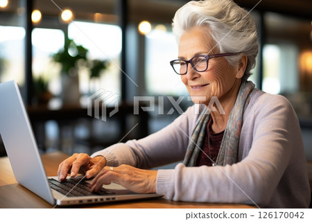 Silver Surfer Serenity Joyful Senior Woman Embraces Technology, Engaging with Laptop to Email Friends, Browse, and Share in Retirement Bliss. created with Generative AI 126170042